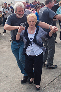 Duncan McGillivray dances with a guest during the Feis Ile ceilidh at the distillery in May, 2010. Photo ©2010 by Mark Gillespie.