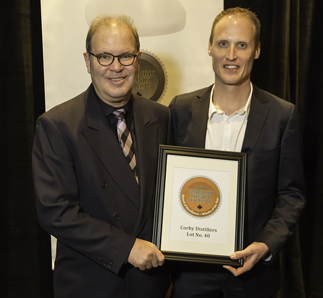 Canadian Whisky Awards founder Davin de Kergommeaux presents Corby's Dr. Don Livermore (R) with the Canadian Whisky of the Year award for Lot No. 40 on January 14,, 2016. Photo ©2016 by Mark Gillespie.