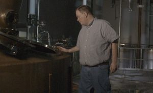 John Lunn with one of the stills at Sazerac's newly-acquired distillery in Newport, Tennessee. Photo courtesy Popcorn Sutton Distilling.