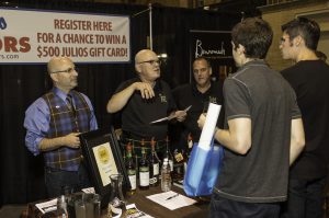 Ryan Maloney of Julio's Liquors (left) and his team at Whisky Live Boston in 2013. Photo ©2013, Mark Gillespie/CaskStrength Media.