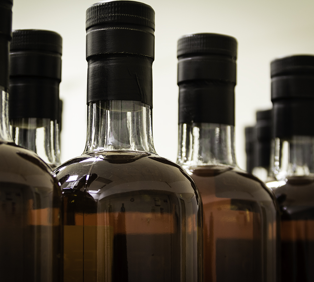 Whisky bottles ready for labeling on the bottling line at Duncan Taylor & Company in Huntly, Scotland. Photo ©2018, Mark Gillespie/CaskStrength Media.