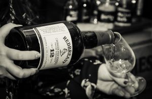 A brand ambassador pours a glass of Redbreast for a guest at the Victoria Whisky Festival January 20, 2018. Photo ©2018, Mark Gillespie/CaskStrength Media.