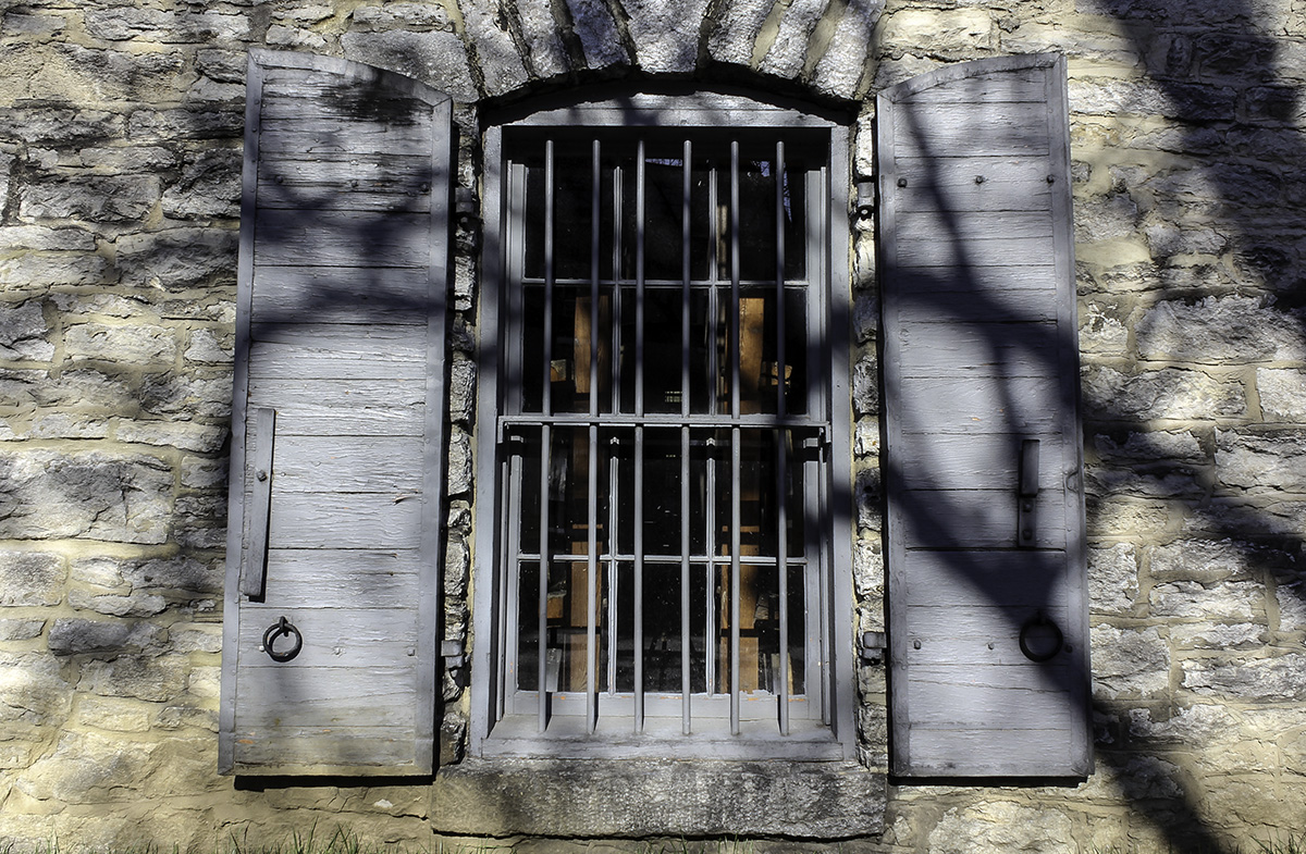 A whiskey warehouse window with bars at Woodford Reserve Distillery. Photo ©2018, Mark Gillespie/CaskStrength Media.