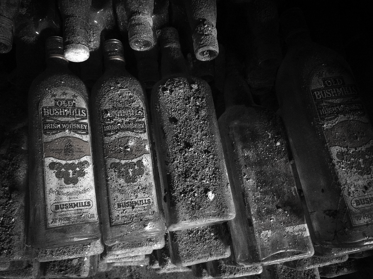 Vintage empty bottles of Bushmills found in the basement of a pub in Waterford, Ireland. File photo ©2019, Mark Gillespie/CaskStrength Media.