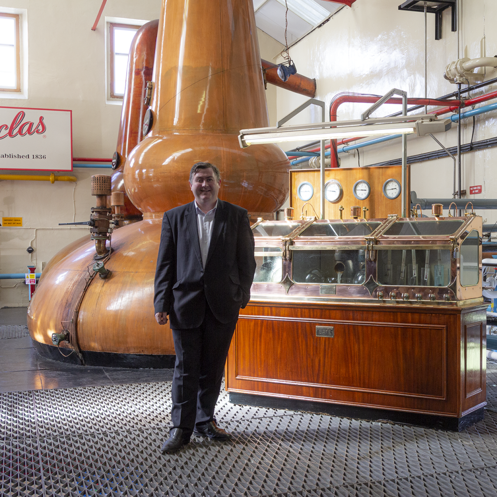 George S. Grant in the Glenfarclas stillhouse. File photo ©2020, Mark Gillespie/CaskStrength Media.