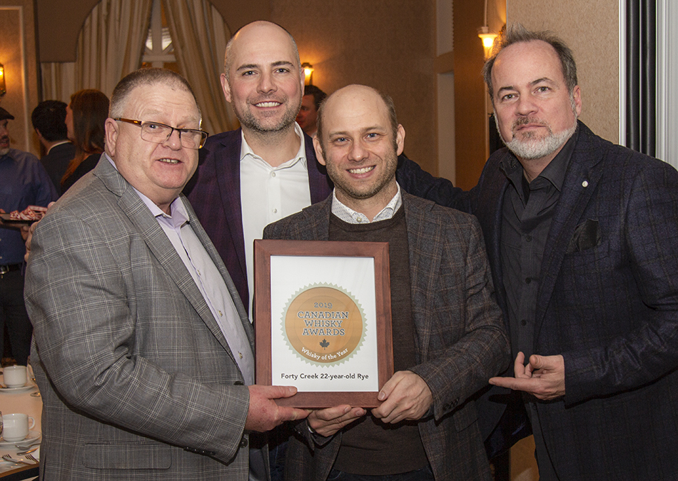 Bill Ashburn (L) and the Forty Creek team celebrate winning Canadian Whisky of the Year honors at the 2019 Canadian Whisky Awards. File photo ©2019, Mark Gillespie/CaskStrength Media.