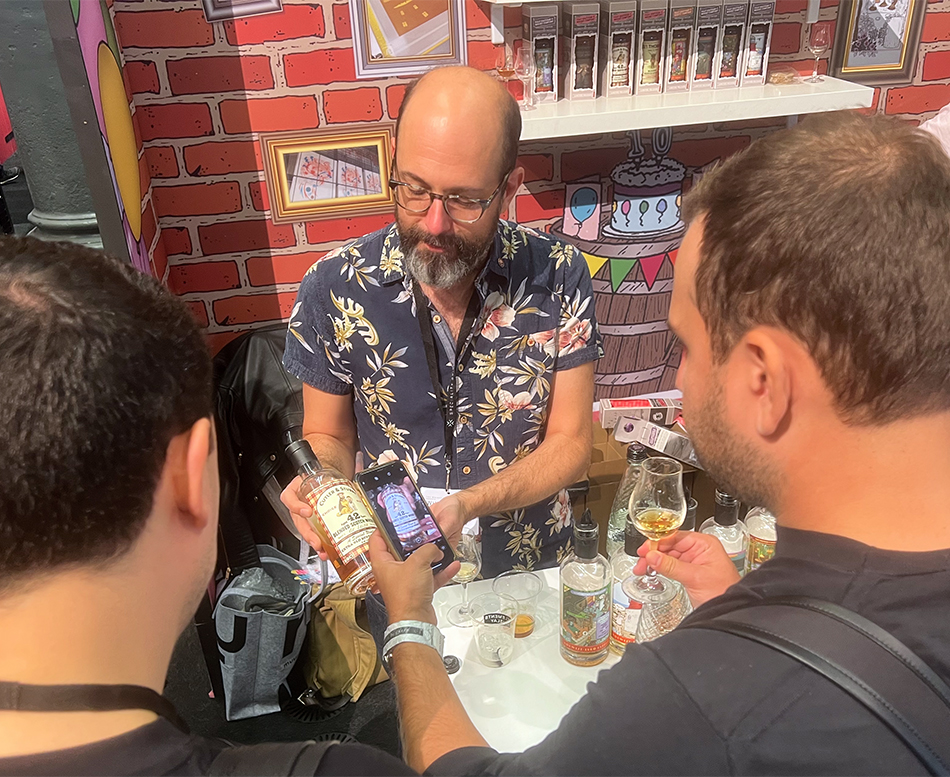 Sam Simmons of That Boutique-y Whisky Company shows off a bottle during The Whisky Show 2022 in London on October 2, 2022. Photo ©2022, Mark Gillespie/CaskStrength Media.